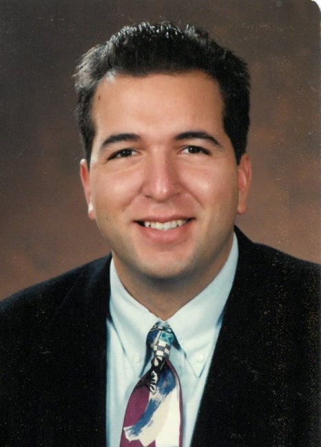 Obituary of David J Rhoades